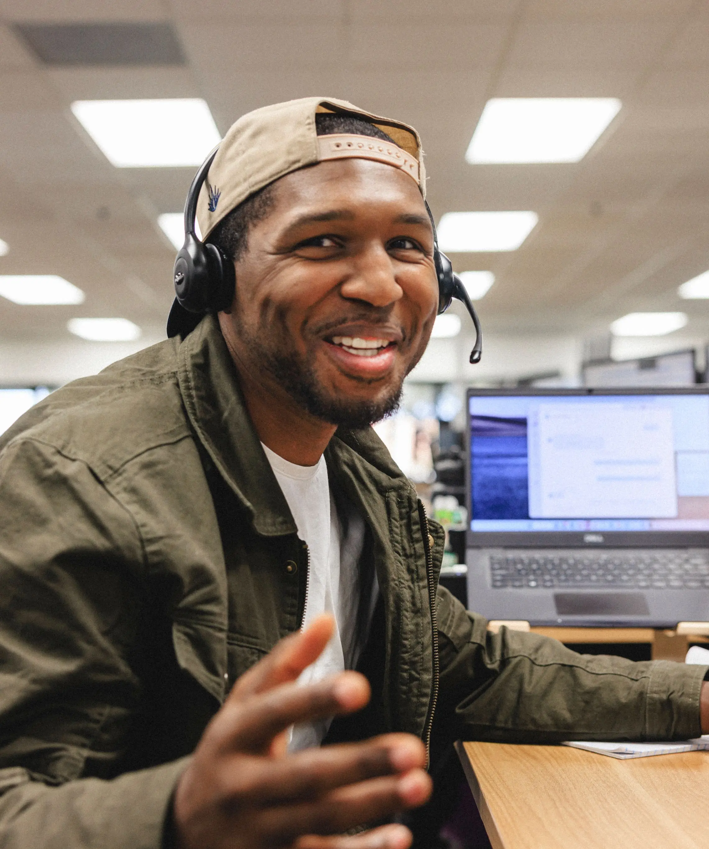 Enthusiastic team member with headset on a phone call