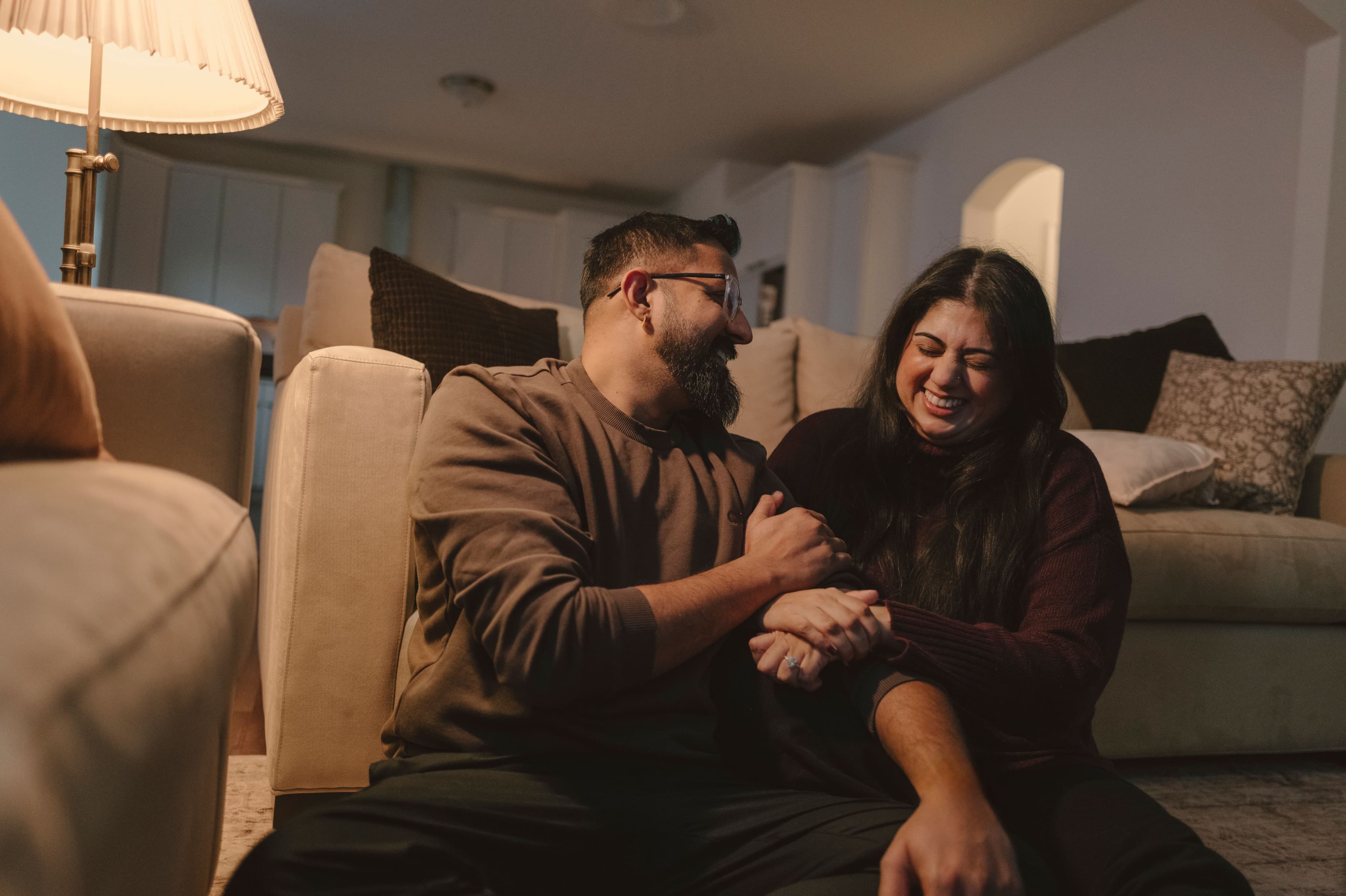 Couple laughing together on couch