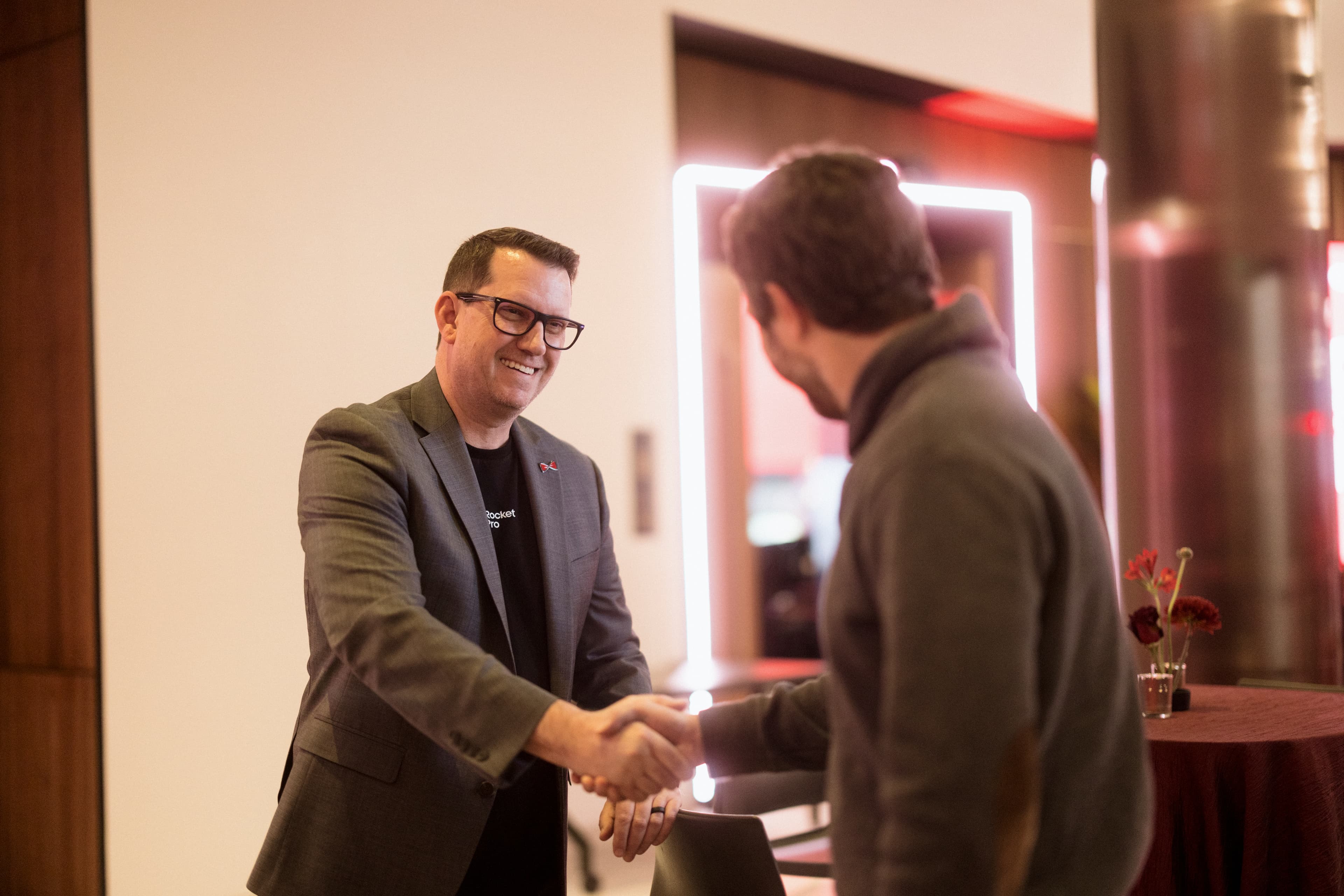 Two men shake hands
