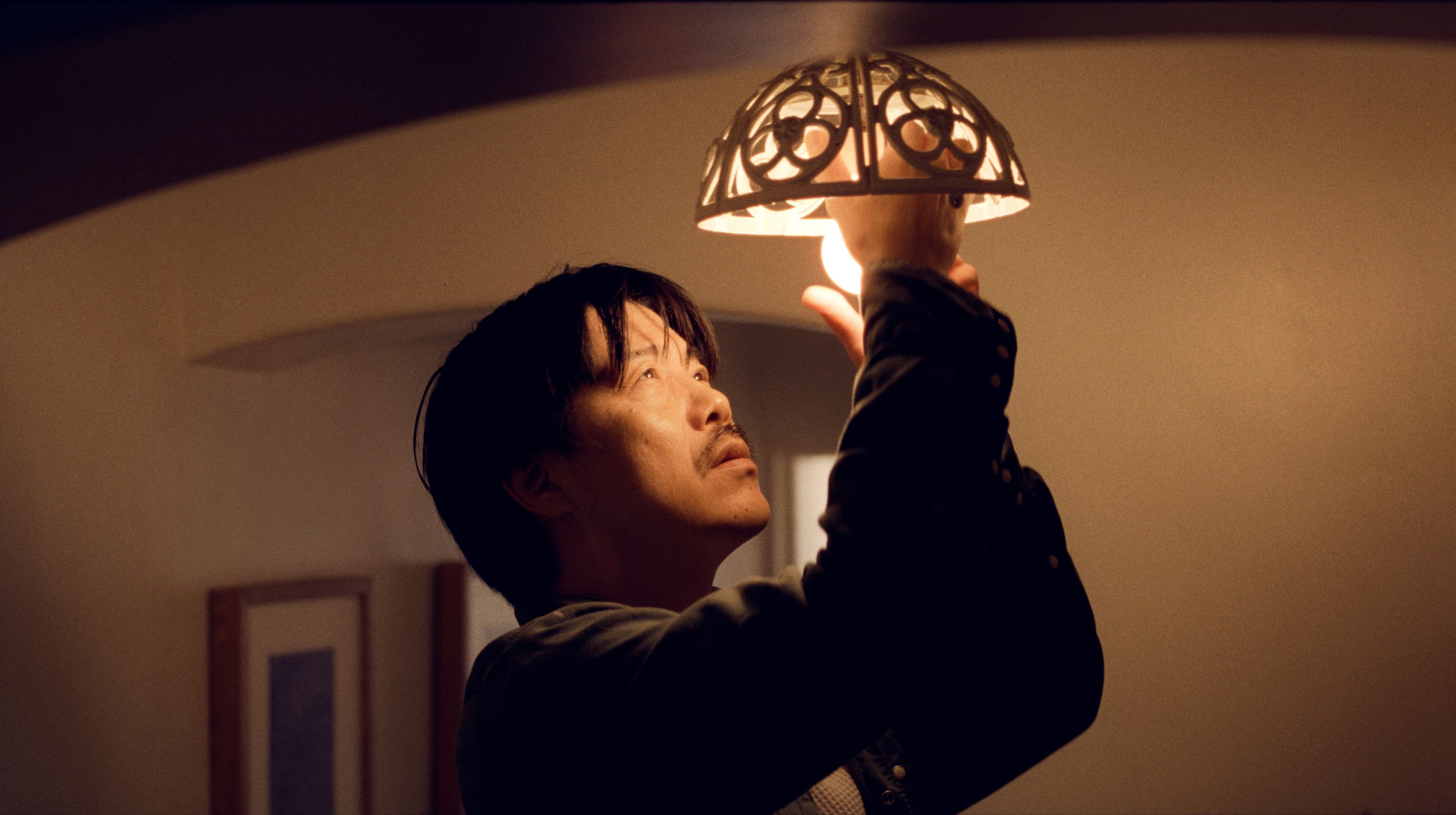 Person install a lightbulb in their home