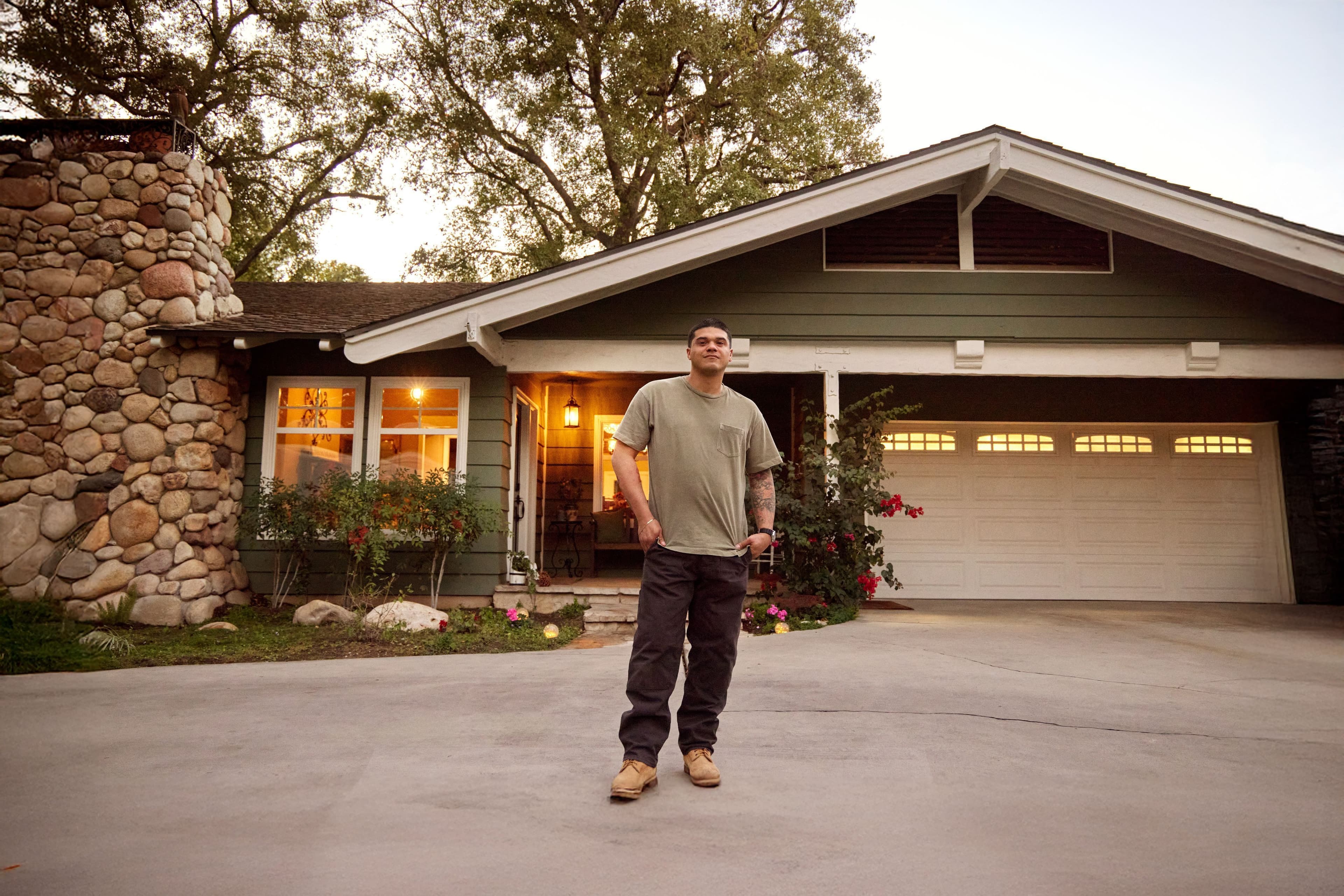 Man outside his home smiling