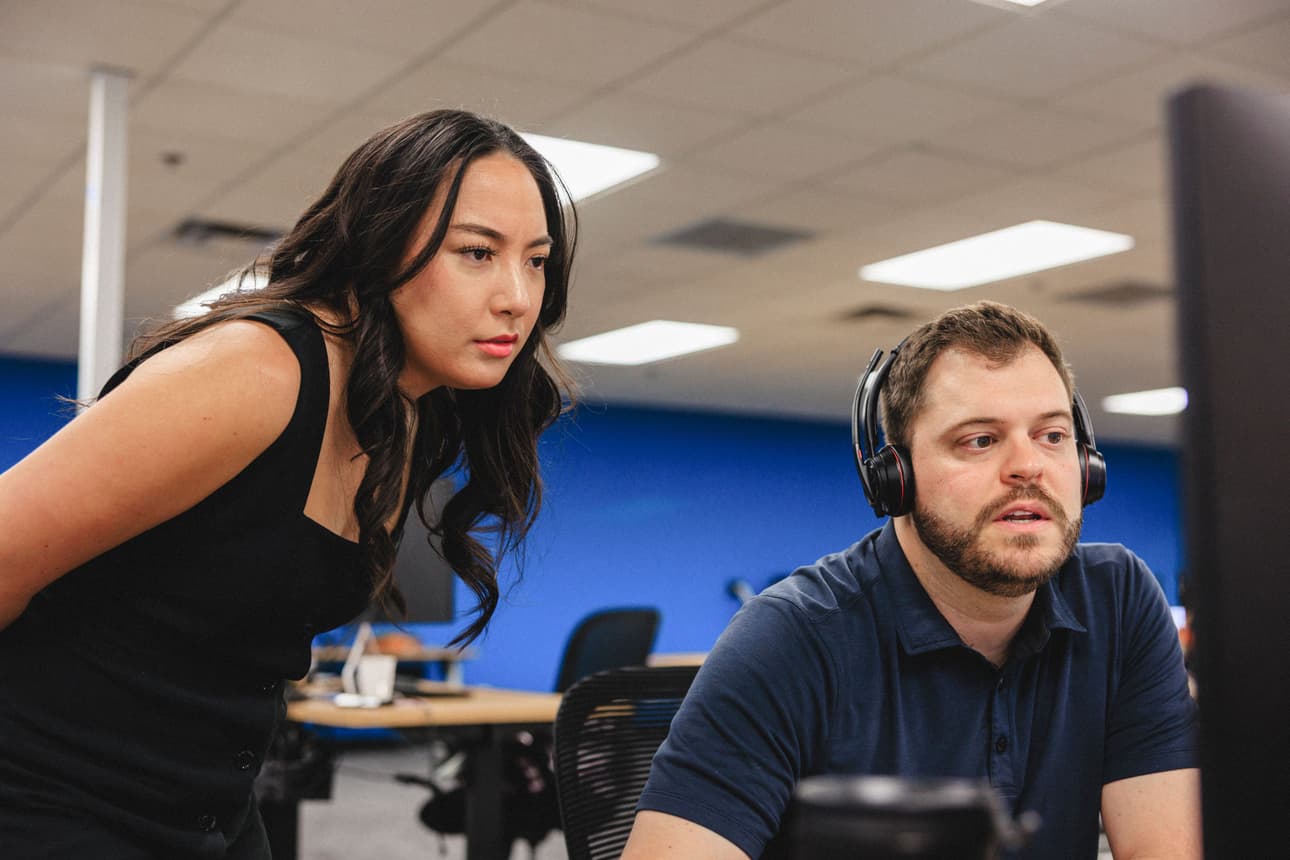 Two team members coordinating at a desk