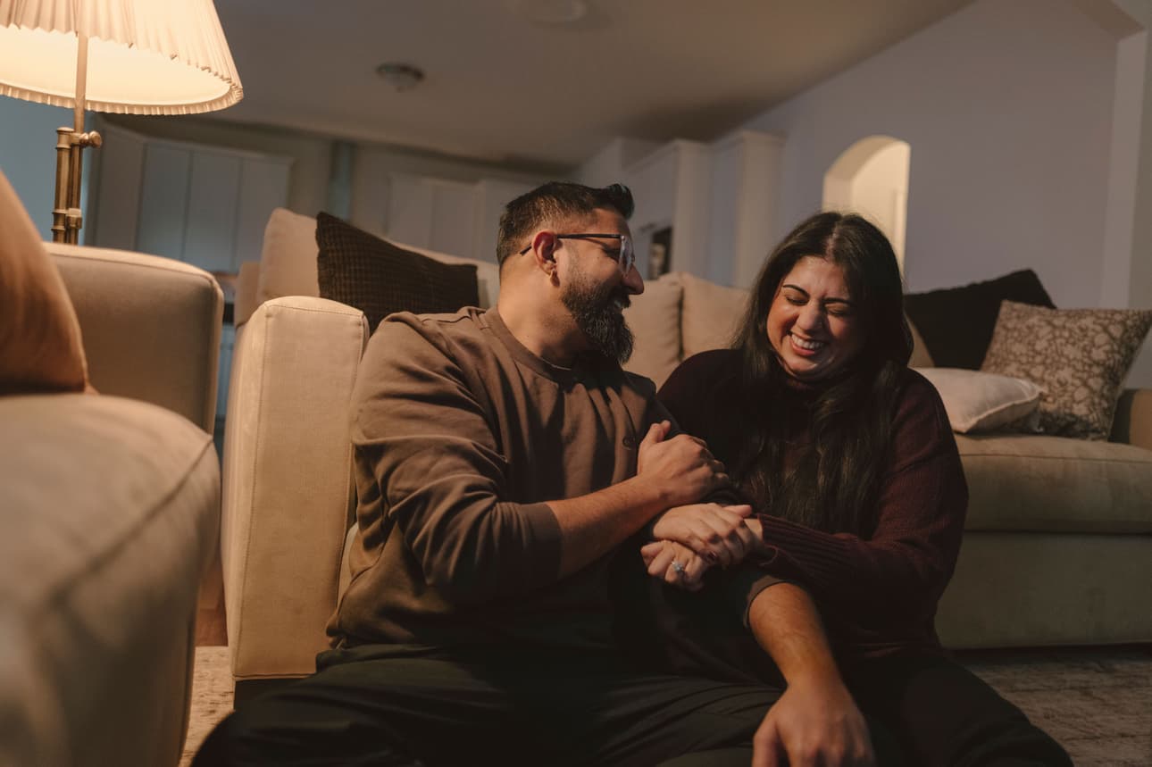 Couple laughing together on couch